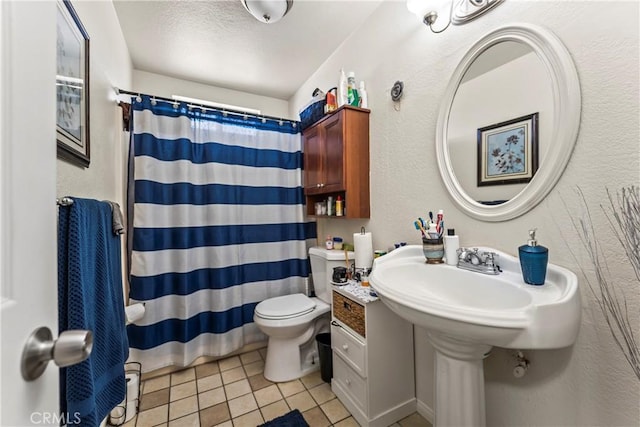 bathroom featuring a shower with curtain, tile patterned floors, and toilet