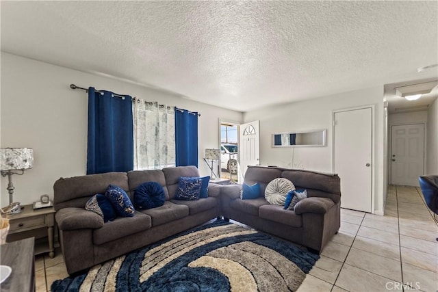 living room with light tile patterned floors and a textured ceiling