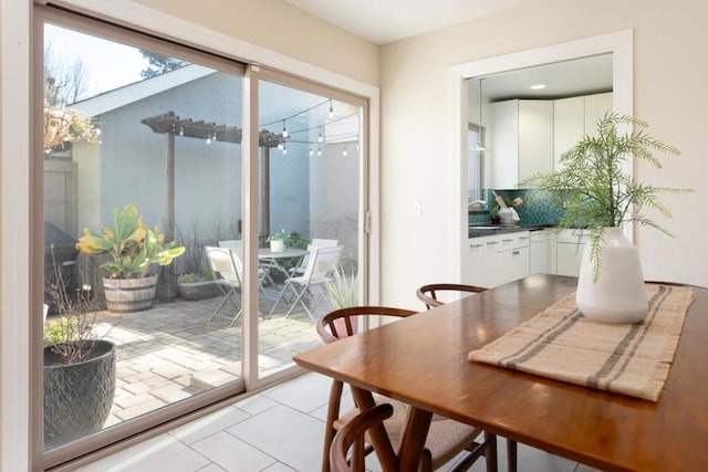 doorway to outside with light tile patterned flooring