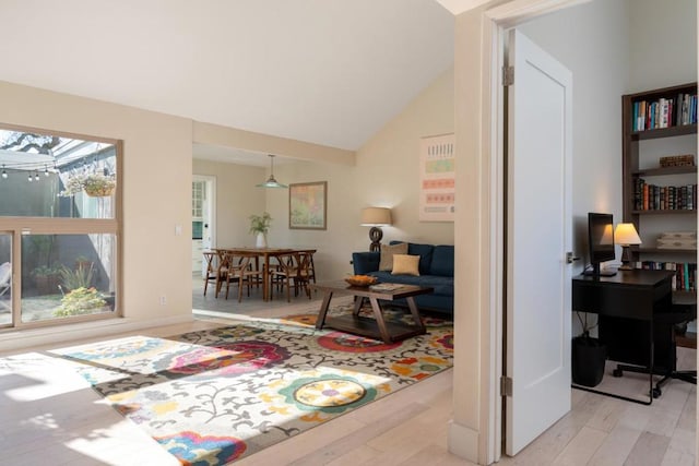 interior space featuring light hardwood / wood-style flooring and lofted ceiling