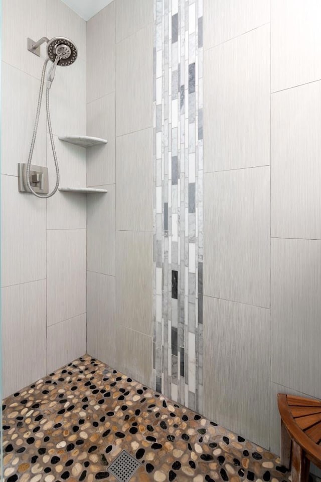 bathroom with a tile shower