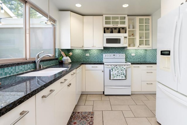 kitchen with white appliances, white cabinetry, decorative light fixtures, and sink