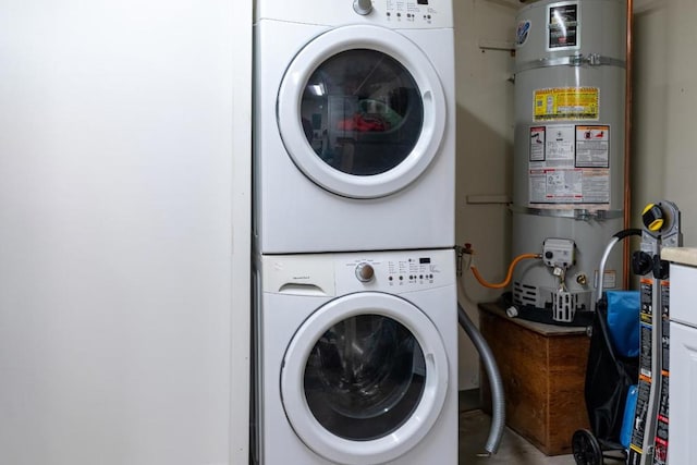 laundry room featuring stacked washer and dryer and secured water heater