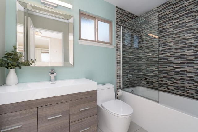 full bathroom with bath / shower combo with glass door, vanity, and toilet