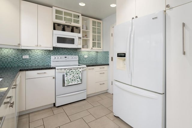 kitchen featuring white appliances, white cabinets, light tile patterned floors, and decorative backsplash