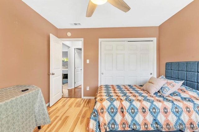 bedroom with ceiling fan, light wood-type flooring, and a closet