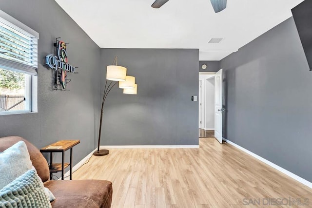 living area featuring ceiling fan and light hardwood / wood-style floors