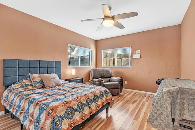 bedroom with ceiling fan and light hardwood / wood-style floors