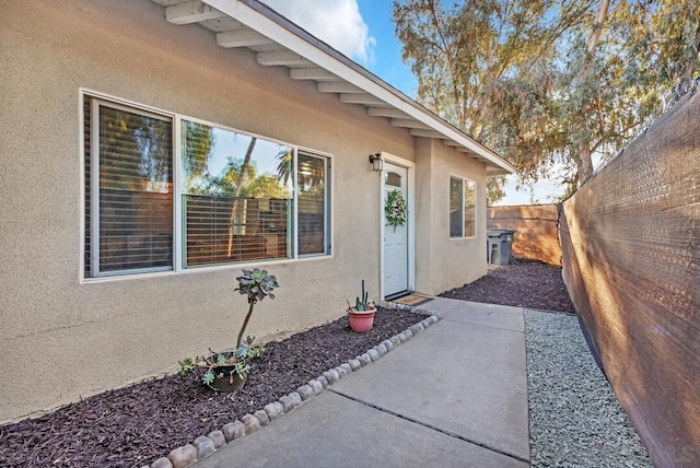 view of exterior entry with a patio