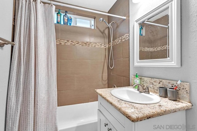 bathroom with shower / tub combo with curtain and vanity