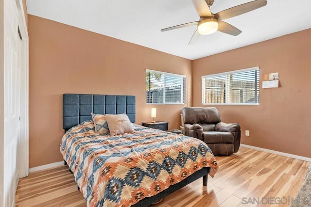 bedroom with a closet, ceiling fan, and light hardwood / wood-style floors