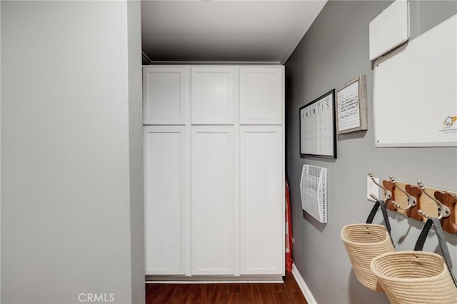 corridor featuring dark hardwood / wood-style flooring and crown molding