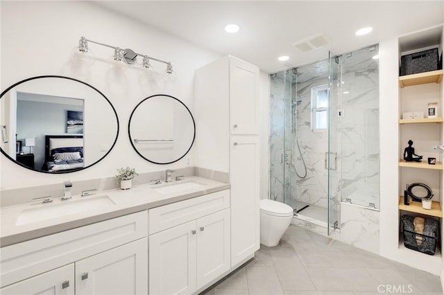 bathroom featuring vanity, toilet, and a shower with shower door