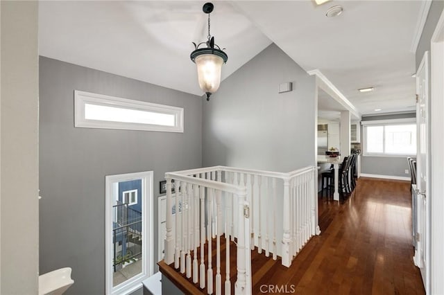 hallway featuring lofted ceiling and dark wood-type flooring