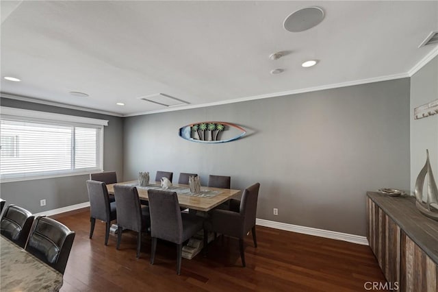 dining space featuring dark hardwood / wood-style flooring and ornamental molding