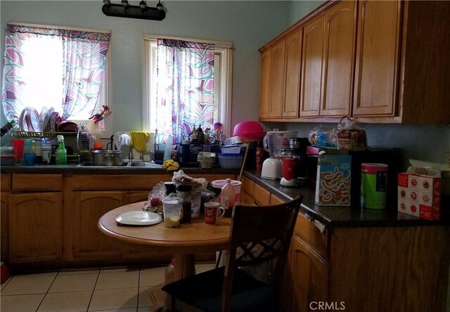 kitchen featuring light tile patterned floors and sink