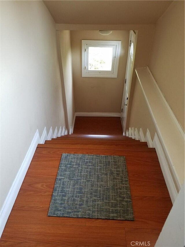 stairs featuring hardwood / wood-style flooring