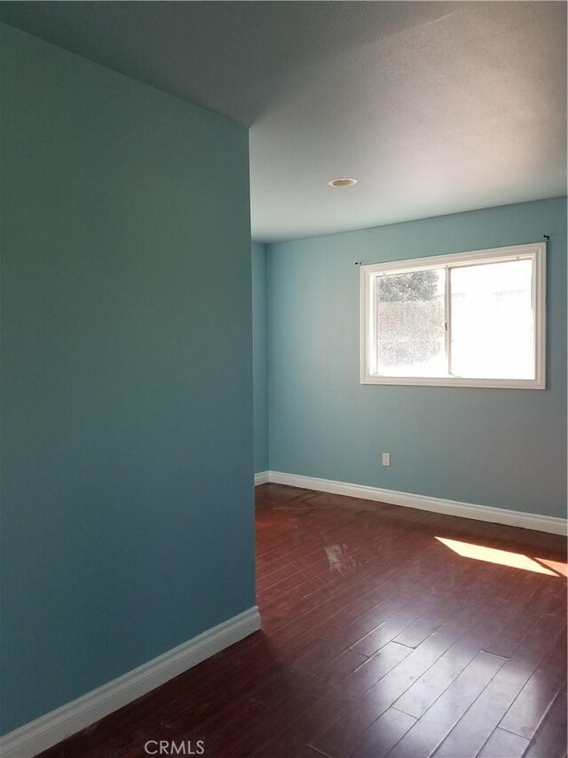 spare room featuring dark hardwood / wood-style floors