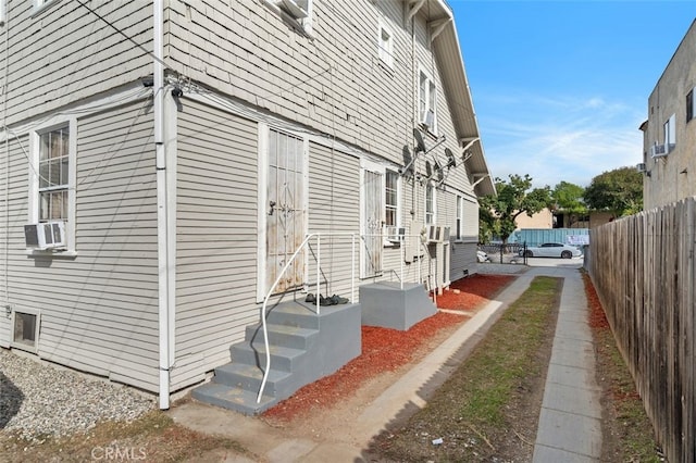 view of home's exterior featuring fence and cooling unit