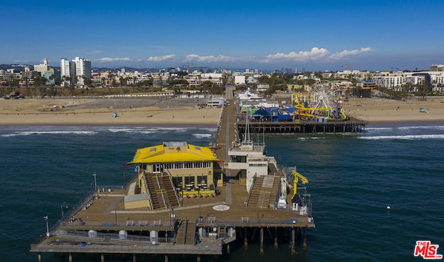 view of dock with a view of the beach and a water view