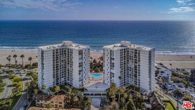 birds eye view of property featuring a view of the beach and a water view