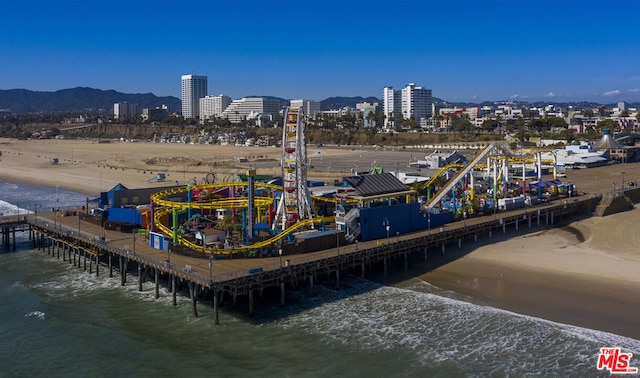 bird's eye view featuring a water and mountain view and a beach view