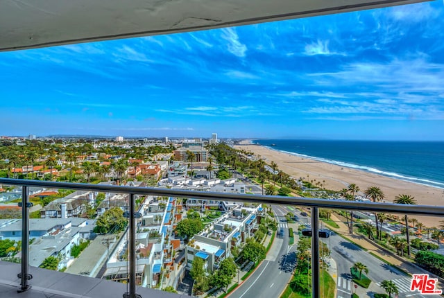 balcony featuring a water view and a beach view