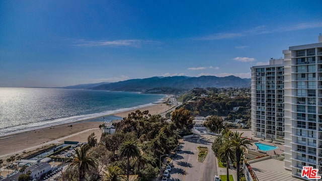 view of water feature with a mountain view and a beach view