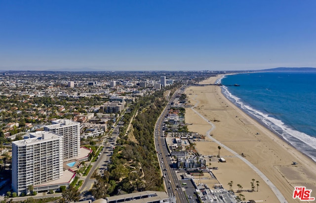 birds eye view of property featuring a water view and a beach view