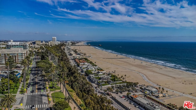 birds eye view of property featuring a water view and a beach view