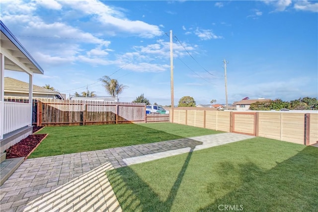 view of yard with a patio area and a fenced backyard