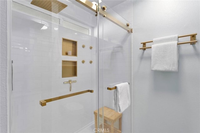 bathroom featuring a shower with shower door