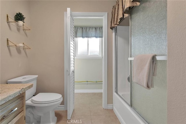 full bathroom with tile patterned floors, vanity, toilet, and bath / shower combo with glass door