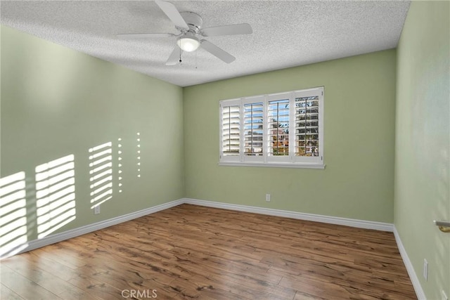 spare room featuring ceiling fan, wood-type flooring, and a textured ceiling