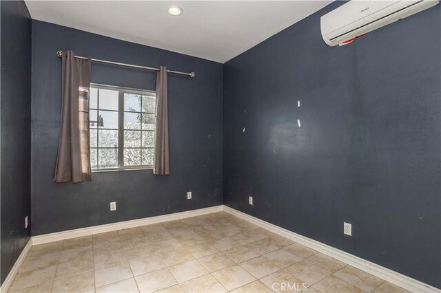 tiled empty room with a wall mounted AC