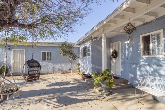 entrance to property with a patio