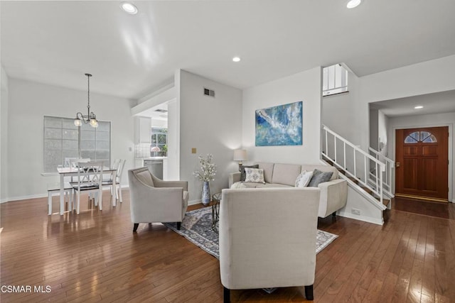 living room featuring dark hardwood / wood-style floors and a chandelier