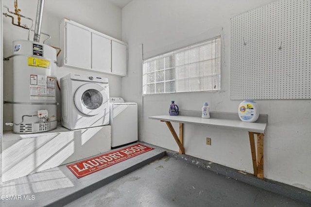 laundry room featuring cabinets, washer and clothes dryer, and water heater