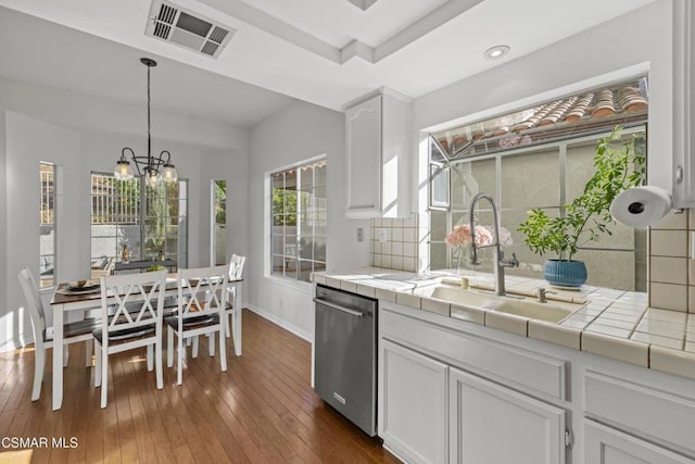 kitchen featuring sink, white cabinetry, tile countertops, hanging light fixtures, and dishwasher