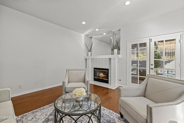 sitting room with wood-type flooring and a fireplace