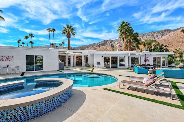 view of pool with a mountain view, an in ground hot tub, and a patio