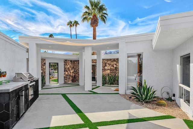 view of patio featuring an outdoor kitchen