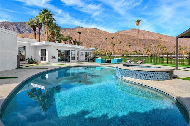 view of pool with a mountain view, an in ground hot tub, and a patio