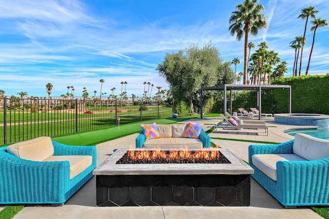 view of patio with an in ground hot tub and an outdoor living space with a fire pit