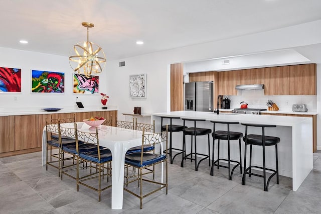 dining space with a notable chandelier and sink