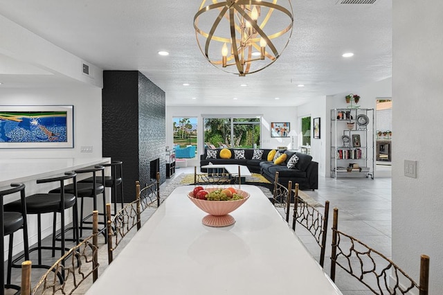 dining space featuring a textured ceiling and an inviting chandelier