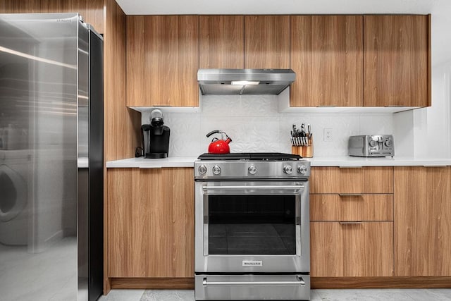 kitchen with stainless steel appliances and tasteful backsplash