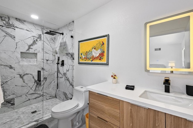 bathroom featuring vanity, toilet, and a shower with shower door