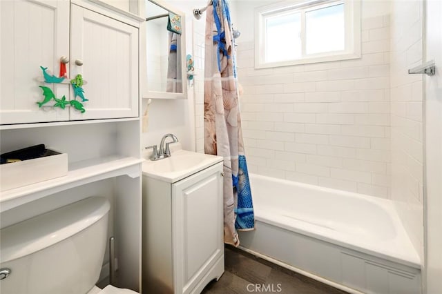 full bathroom with shower / bath combo with shower curtain, toilet, and vanity