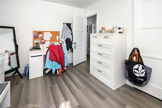 bedroom with dark wood-type flooring